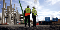 Conack Construction workers looking at a project on site, planning safety with HammerTech