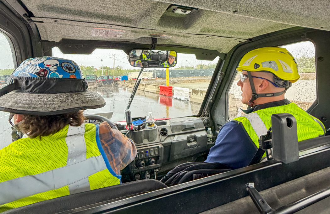 Holder Construction workers in a work vehicle on a job site using HammerTech construction safety platform
